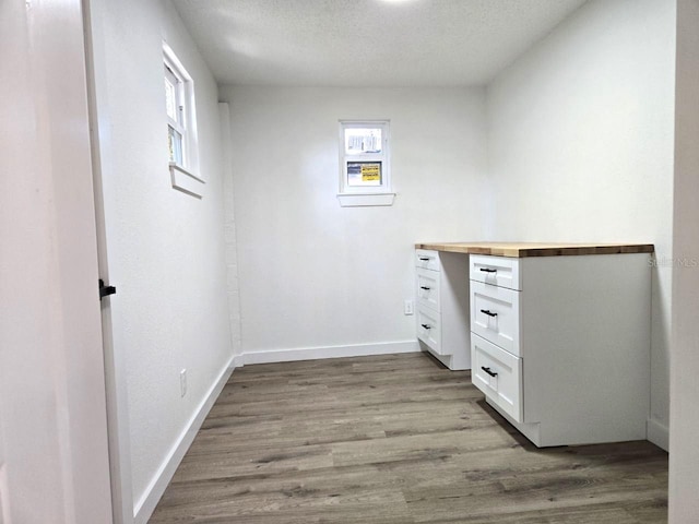 interior space with light hardwood / wood-style floors and a textured ceiling