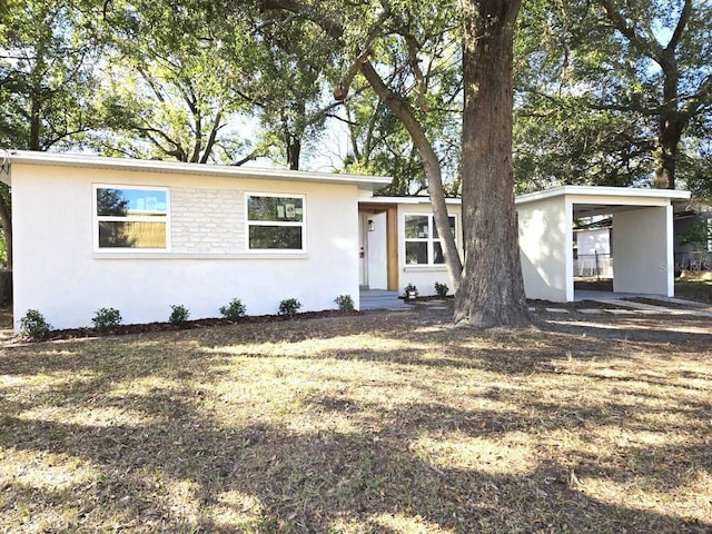 ranch-style home featuring a carport