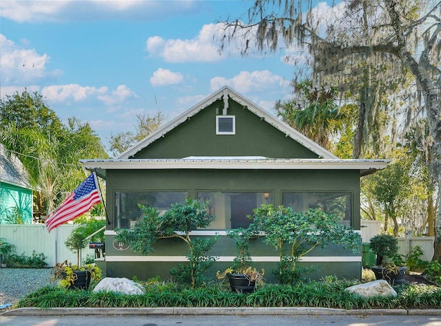 view of property exterior with a sunroom