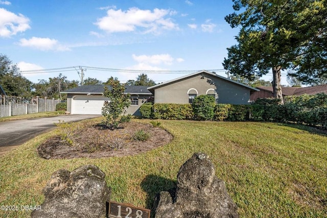 ranch-style house with a garage and a front yard