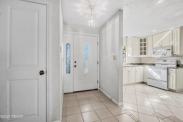 foyer entrance with light tile patterned floors