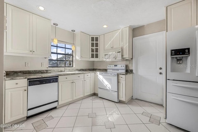 kitchen with white cabinetry, sink, white appliances, and decorative light fixtures