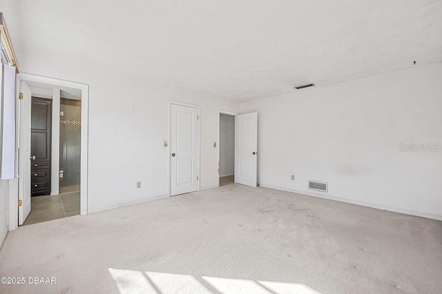 empty room with light colored carpet