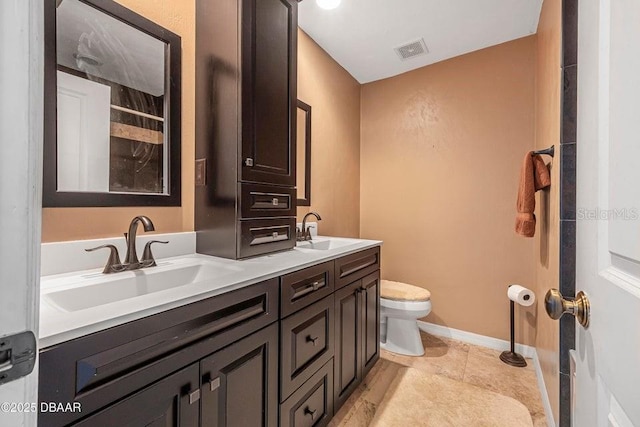 bathroom featuring vanity, tile patterned floors, and toilet