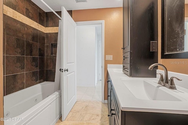 bathroom featuring shower / bath combo and vanity