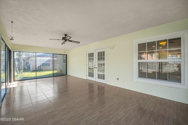 unfurnished sunroom with french doors and ceiling fan