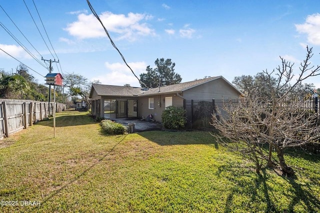 rear view of house with a patio and a lawn