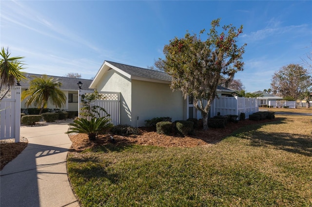 view of property exterior featuring a lawn