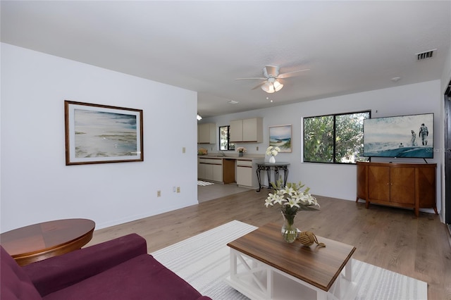 living room featuring ceiling fan and light wood-type flooring