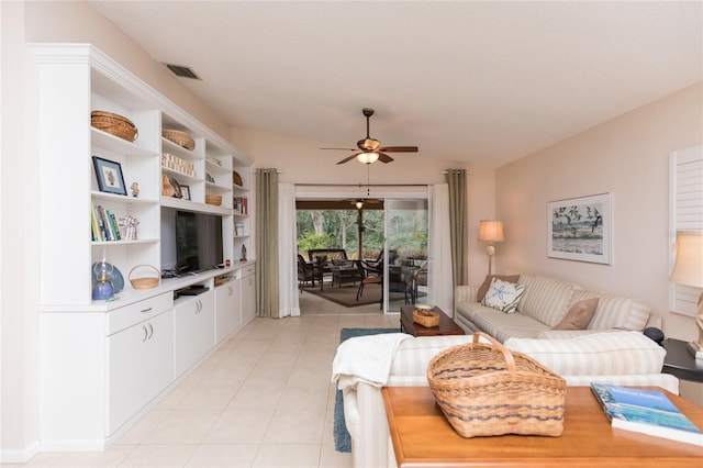 living room with ceiling fan, lofted ceiling, and light tile patterned floors