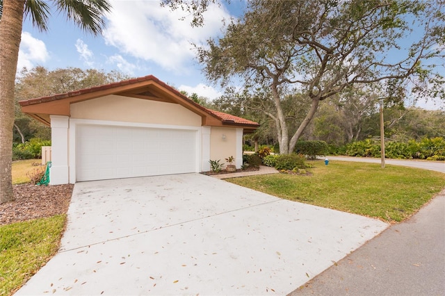 view of front of home featuring a garage and a front lawn