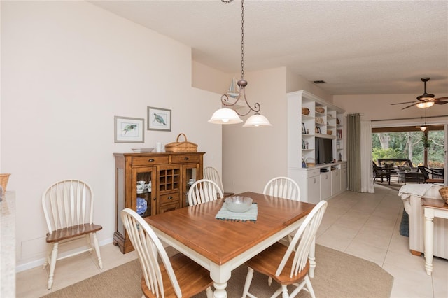 tiled dining area featuring a textured ceiling and ceiling fan