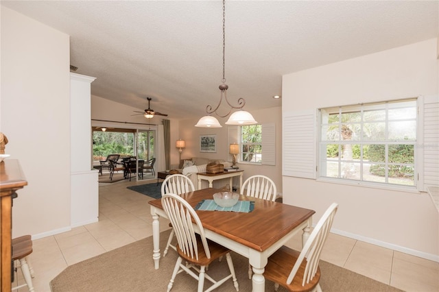 tiled dining space with ceiling fan, a textured ceiling, and a wealth of natural light