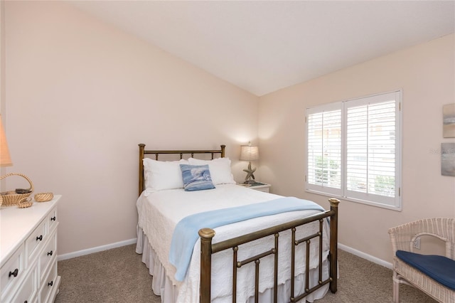 bedroom with light colored carpet and vaulted ceiling