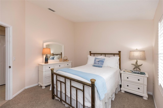 bedroom featuring light colored carpet