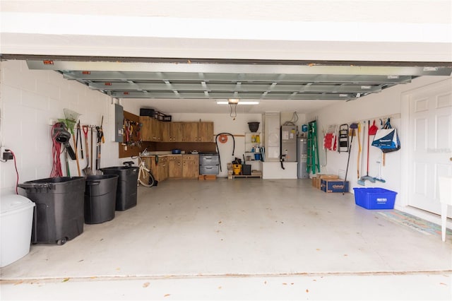 garage with electric water heater and electric panel