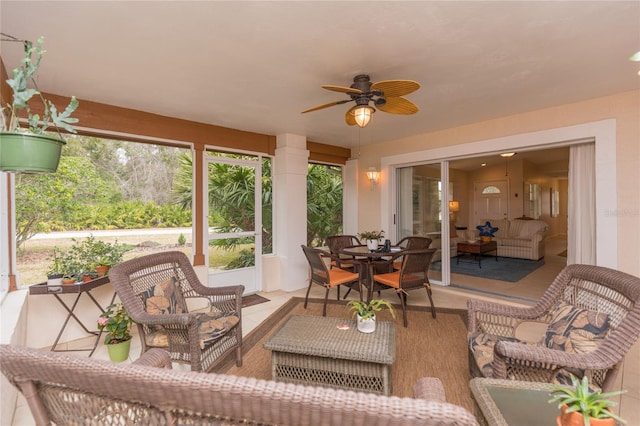 sunroom featuring ceiling fan