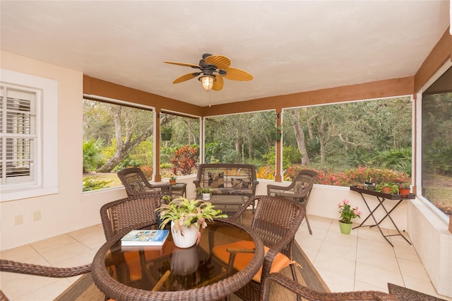 sunroom / solarium featuring ceiling fan