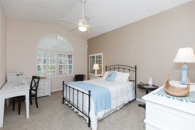 bedroom featuring ceiling fan, vaulted ceiling, and light carpet