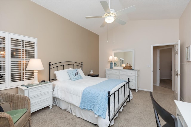 bedroom featuring vaulted ceiling, light colored carpet, and ceiling fan