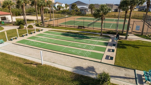 view of property's community with tennis court, a lawn, and volleyball court