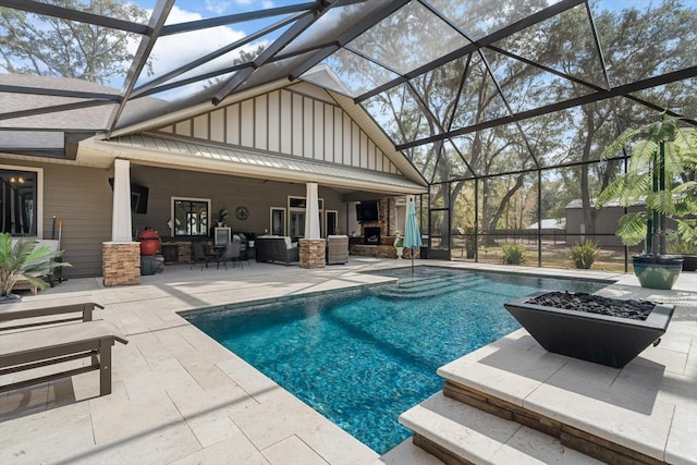 view of pool with ceiling fan, a patio area, and glass enclosure