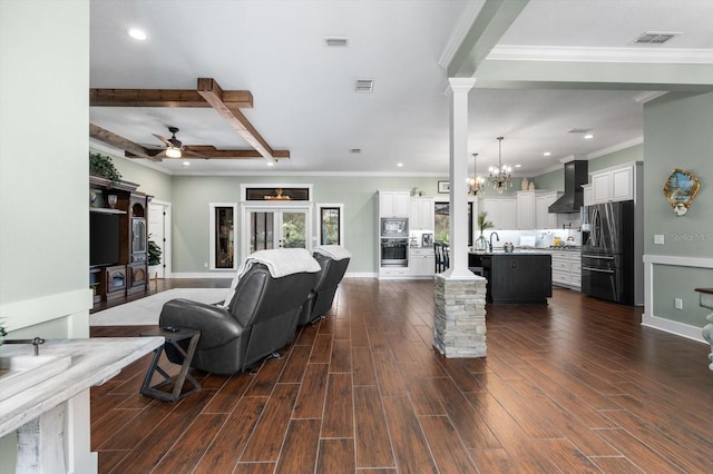 living room featuring sink, crown molding, beam ceiling, decorative columns, and dark hardwood / wood-style flooring