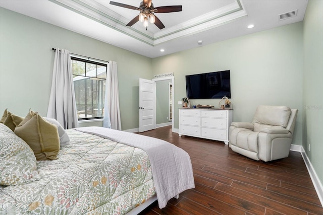 bedroom with ceiling fan, ornamental molding, dark hardwood / wood-style floors, and a raised ceiling