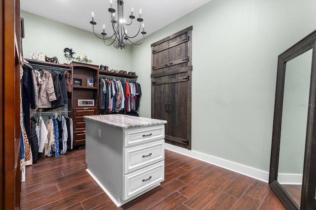 walk in closet with a chandelier