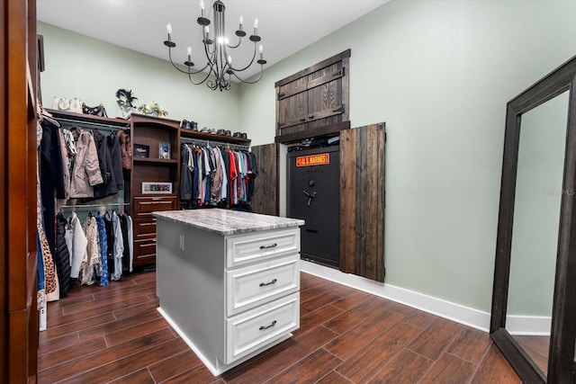 spacious closet featuring a chandelier