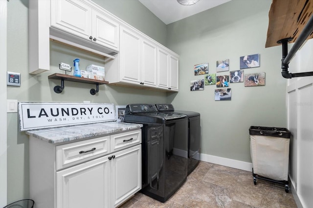 laundry room with cabinets and washer and dryer