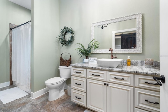 bathroom featuring vanity, curtained shower, and toilet