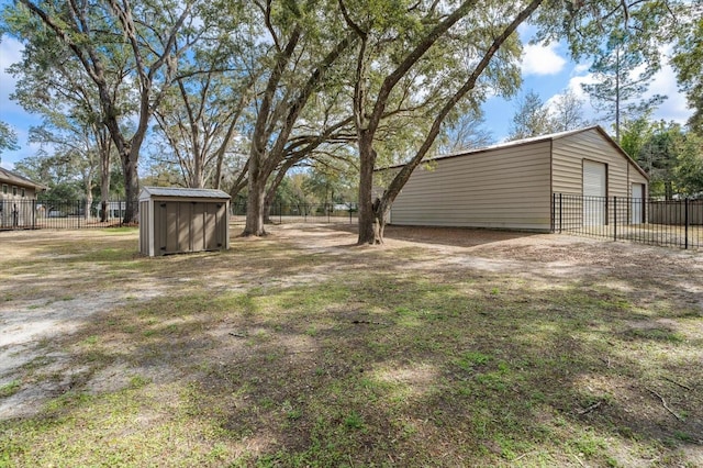 view of yard featuring a storage shed and a garage