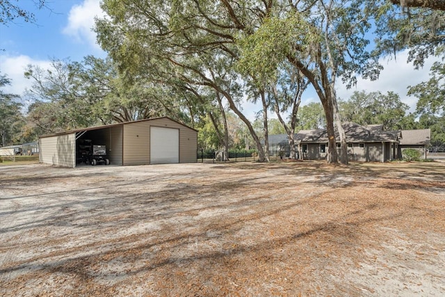 view of yard with a carport and a garage