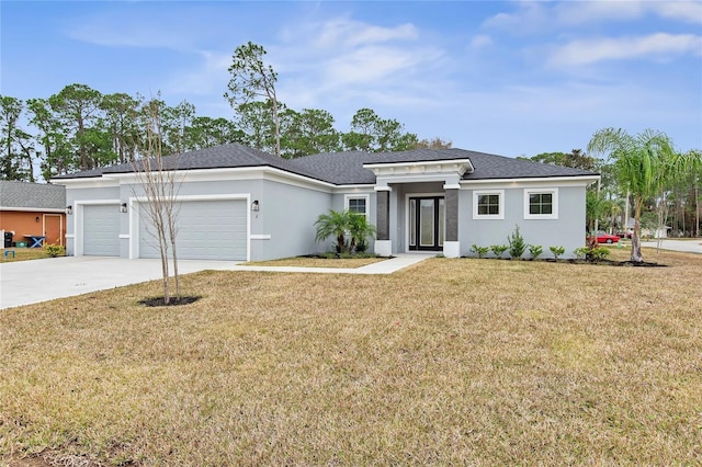 prairie-style home featuring a garage and a front lawn