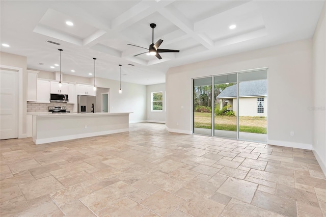 unfurnished living room featuring a high ceiling, coffered ceiling, and beam ceiling