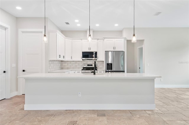 kitchen with white cabinetry, sink, decorative light fixtures, and appliances with stainless steel finishes