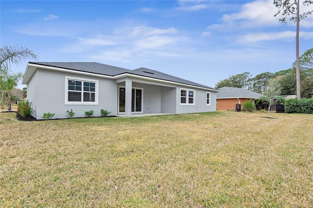 rear view of property featuring a yard