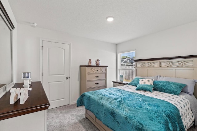 carpeted bedroom featuring a textured ceiling