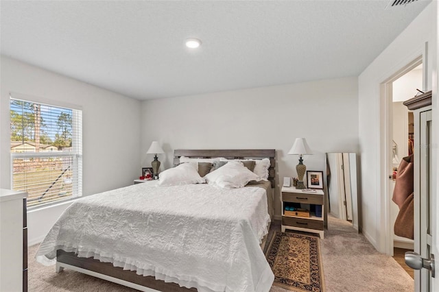 bedroom with light colored carpet