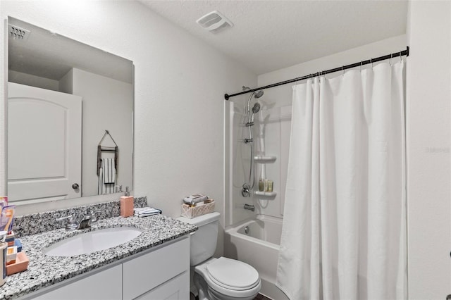 full bathroom with vanity, toilet, shower / tub combo, and a textured ceiling