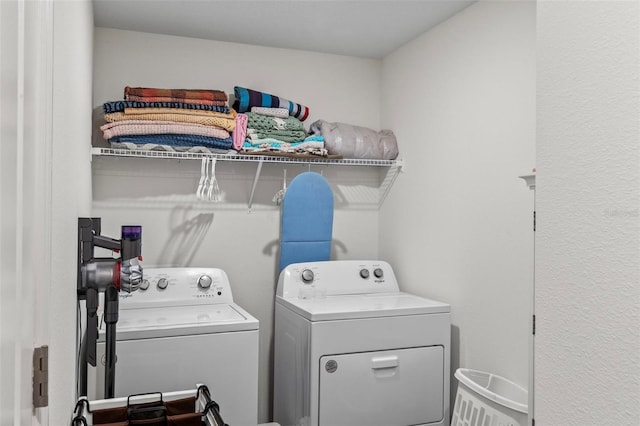 clothes washing area with washing machine and clothes dryer