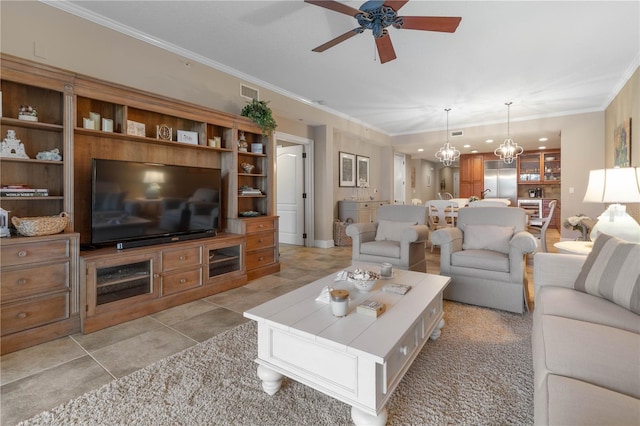 living room featuring crown molding, ceiling fan with notable chandelier, and light tile patterned flooring