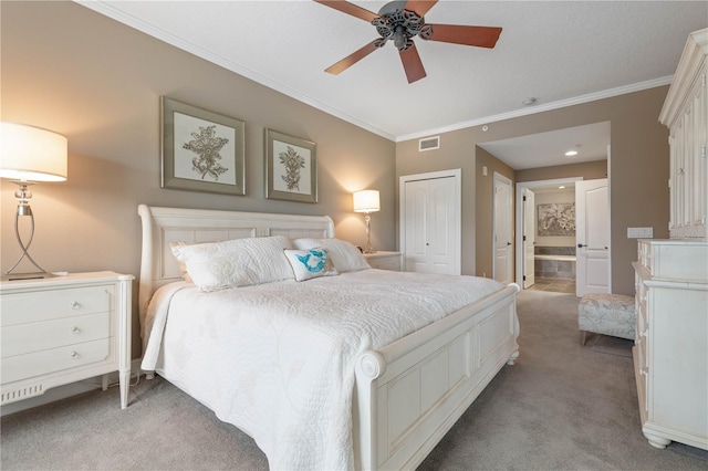 carpeted bedroom featuring crown molding, ensuite bath, and ceiling fan