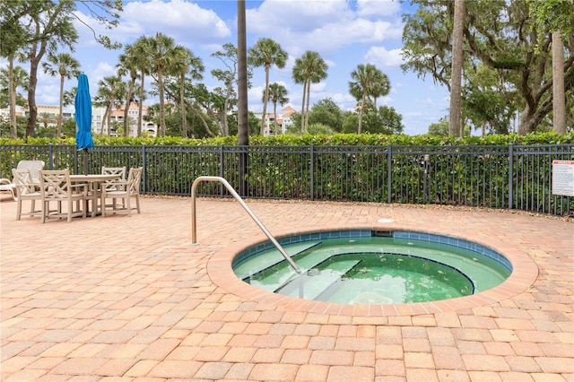 view of pool featuring a community hot tub and a patio area