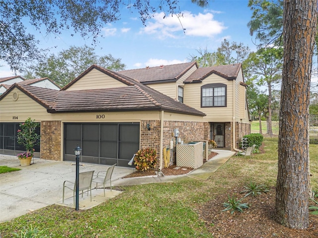 view of front of home featuring a garage and a front lawn