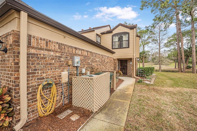 view of side of home featuring a lawn