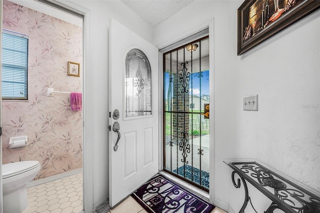 foyer entrance featuring a textured ceiling