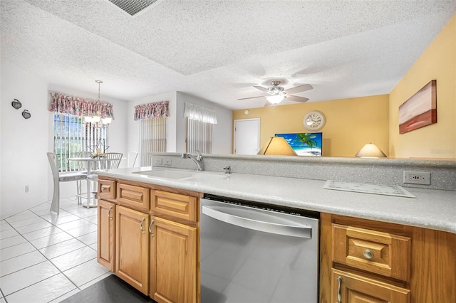 kitchen with dishwasher, sink, hanging light fixtures, light tile patterned floors, and a textured ceiling