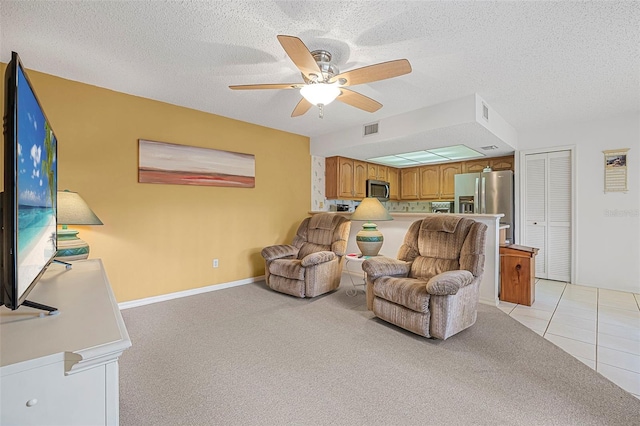 carpeted living room featuring a textured ceiling and ceiling fan